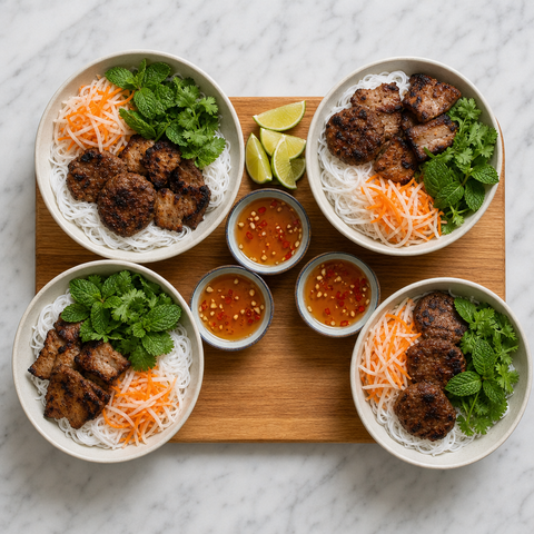 Complete Bun Cha served with noodles, herbs, pickles, pork, and dipping broth