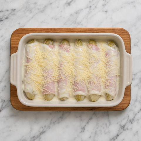 Ham-wrapped endives covered with béchamel and Gruyère