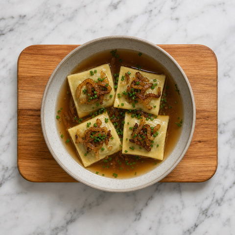 Swabian filled pasta pockets in broth with caramelized onions and chives