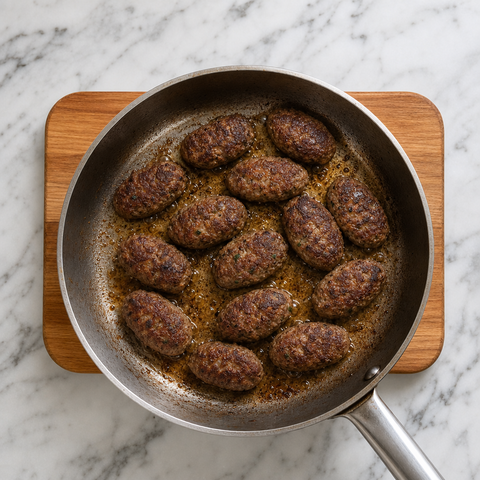 Turkish köfte browning in a skillet