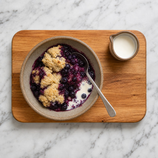 Warm blueberry grunt served in a bowl with tender dumplings
