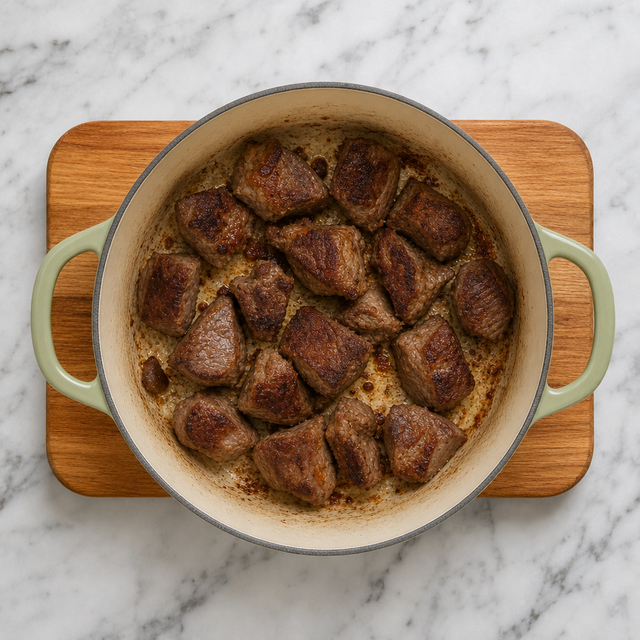 Lamb cubes deeply browned in a Dutch oven