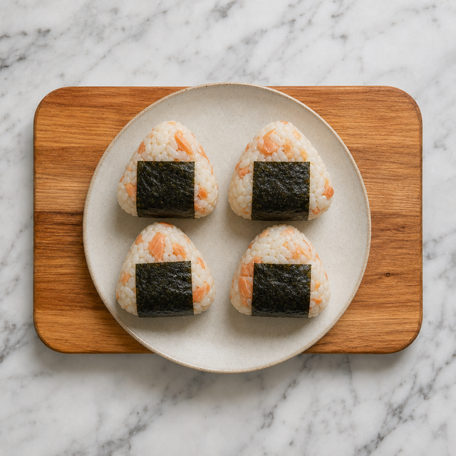 Four triangular salmon onigiri wrapped with nori